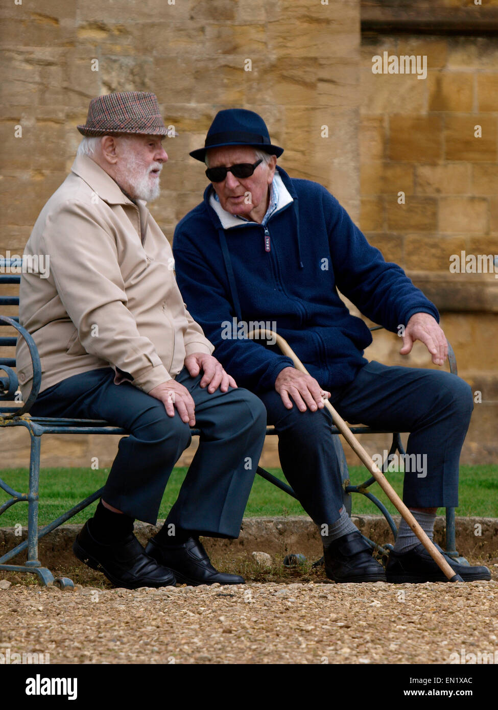 two-old-men-sat-on-a-public-bench-sherborne-uk-EN1XAC.jpg